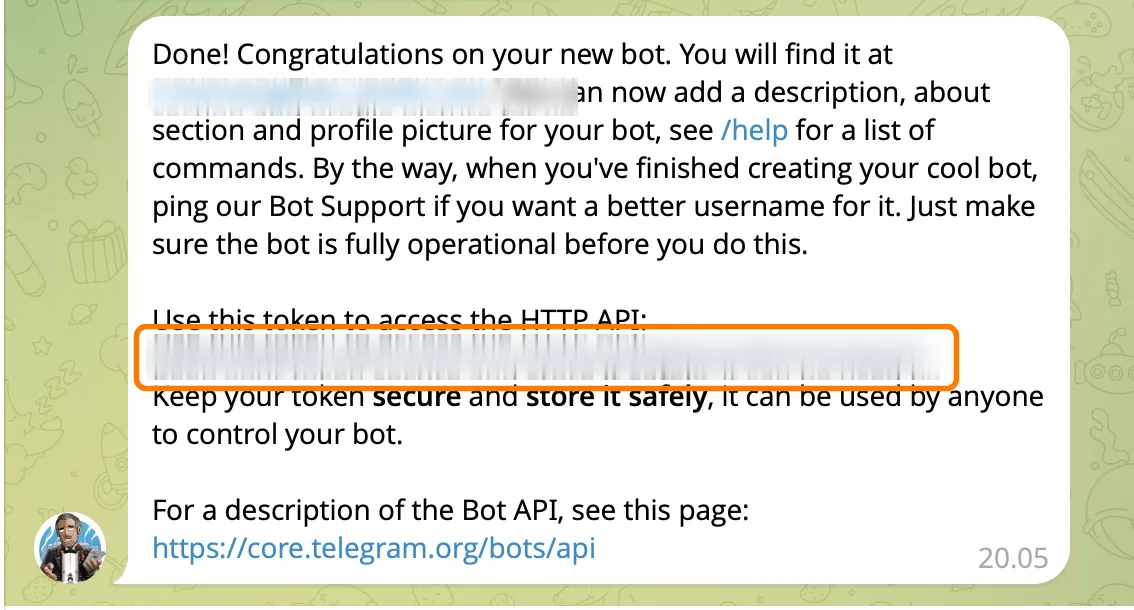 Сообщение BotFather: бот создан, ключ в оранжевой рамке размыт